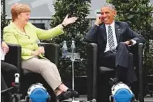  ?? Reuters ?? German Chancellor Angela Merkel and Barack Obama attend a discussion at the German Protestant Kirchentag in front of the Brandenbur­g Gate in Berlin, yesterday.