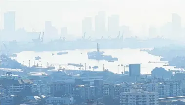  ?? REUTERS ?? Cargo ships are seen through air pollution along the Chao Phraya River in Bangkok in November last year. The government has thus far been unable — or even unwilling, to curb the emissions that cause this toxic smog.