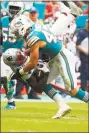  ?? Wilfredo Lee / Associated Press ?? Dolphins linebacker Kiko Alonso tackles Patriots wide receiver Josh Gordon during the second half on Sunday.