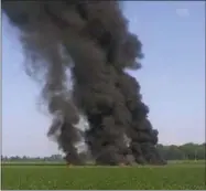  ?? JIMMY TAYLOR VIA AP ?? In this photo provided by Jimmy Taylor, smoke and flames rise into the air after a military transport airplane crashed in a field near Itta Bena, Miss., on the western edge of Leflore County, Monday, killing several.