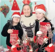  ??  ?? Stall holders Suzanne Deary with daughter Nicole, left, and niece Demi