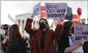  ?? JACQUELYN MARTIN — THE ASSOCIATED PRESS FILE ?? Emily Halvorson, center, of Washington, with Planned Parenthood, joins groups of abortion-rights and antiaborti­on activists as they rally outside the Supreme Court on Capitol Hill in Washington.