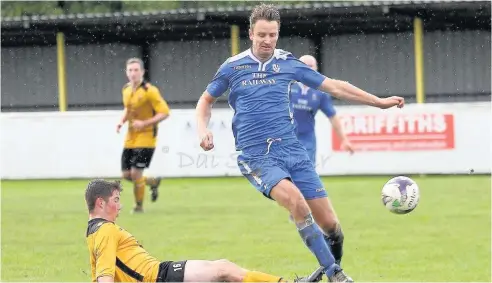  ??  ?? Llangefni Town’s Craig Roberts (blue) scored twice against Llandyrnog United. Picture: DAI SINCLAIR