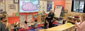  ?? Spencer Lahr / RN-T ?? South Rome Early Learning Center teacher Allyson Chambers (back) leads students in a song while Berry students follow along with the gestures to model for the kids Thursday.