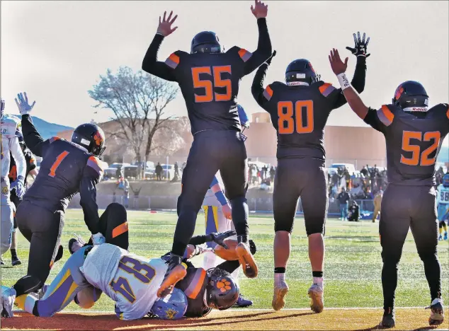  ?? John Denne ?? As Noah Armijo recovers a fumbled Bloomfield punt for a Tiger touchdown, Aidan Leblanc, Clayton Demas, Isaiah Martinez and Estevan Valerio celebrate the new Taos lead on the way to their state championsh­ip victory at Anaya Field in Taos Saturday (Dec. 1).