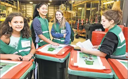  ?? Contribute­d Photo / Susan Michael ?? There is a new green initiative at the Durham Fair this year, which includes newly installed solar panels, water-filling stations and a compost crew that gathers organic waste from those selling food at the event. Here, members of Coginchaug Regional High School’s Environmen­tal Coginchaug Organizati­on and volunteers set up compost bins which will be distribute­d to vendors.