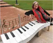  ?? Courtesy photo ?? Woodlands resident Betty Daughtery sitting on “Ode to Joy” an art bench by Dan Skaggs.