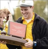  ?? DIGITAL FIRST MEDIA FILE PHOTO ?? Delone Catholic girls cross country head coach Richard Zinn is all smiles after being handed the PIAA District Three Cross Country A championsh­ip trophy Oct. 23, 2013.