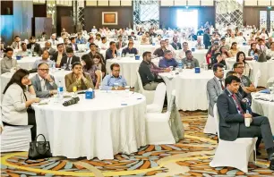  ?? — Photos by Neeraj Murali ?? Naveen Sharma felicitate­s Dr Raed Safadi at a seminar organised by the Institute of Chartered Accountant­s of India — Dubai chapter on Saturday; (right) delegates listen to experts speaking about the UAE’s value-added tax and the process to automate VAT...