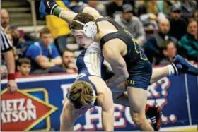  ?? NATE HECKENBERG­ER - FOR DFM ?? Pope John Paul’s Ryan Vulakh return’s Kiski’s Cam Conner in a 4-0 win in the 145-pound quarterfin­als on Day 2 of the PIAA Championsh­ips Friday in Hershey.