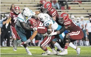  ?? PAUL KIEU THE ASSOCIATED PRESS FILE PHOTO ?? Louisiana-Lafayette running back Elijah Mitchell is tackled by Coastal Carolina linebacker Enock Makonzo (43) and safety Cameron Mitchell in Lafayette, La., on Oct. 14.