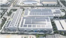  ?? ?? Rooftop solar panels are installed at an industrial site to take advantage of the larger surface areas.