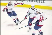  ?? PAUL VERNON — THE ASSOCIATED PRESS ?? The Capitals’ Lars Eller, center, scored in the second overtime Tuesday to give Washington its first win in the playoff series against Columbus.