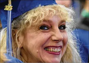  ?? MATT BUTTON/THE AEGIS/BALTIMORE SUN/TNS ?? Debbie Jones can’t hold back her smile as she and fellow graduates prepare to cross the stage during the Harford Communuty College ceremony last month.