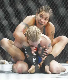  ?? CP PHOTO ?? Amanda Nunes of Brazil, top, grapples with Valentina Shevchenko of Kyrgyzstan during their mixed martial arts bout at UFC 215 in Edmonton on Saturday.