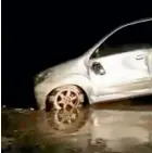  ??  ?? A car sits in mud after being caught by a tsunami in Serang city.
