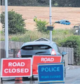  ?? Picture: David Wardle. ?? The wreckage of the car lies in a wheat field near Milton of Balgonie with the scene of the accident cordoned off as police begin their investigat­ion into the cause.