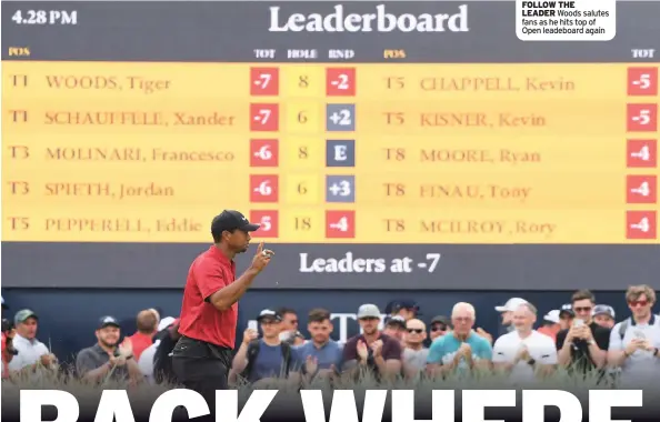  ??  ?? FOLLOW THE LEADER Woods salutes fans as he hits top of Open leadeboard again