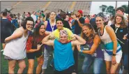  ?? (Courtesy Photo/Gary Schottle) ?? Tank Schottle is joined by coaches and volunteers during a victory celebratio­n at the Texas Special Olympics track meet in Arlington, Texas, in 2017. As a young boy, he was reserved, didn’t really have any friends and was a target for mean-spirited kids. In the 20 years since he started in Special Olympics, Tank has become a leader on the playing fields, the Houston area and beyond.