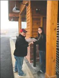  ?? Submitted photo ?? ON THE HOUSE: Ouachita Children’s Center Kitchen Manager Tyson Cooley, left, receives donated Texas Roadhouse meals from their marketing director, Amber Walsh, as part of the restaurant’s preparatio­n before their grand opening Monday. The restaurant held a soft opening with donations collected to benefit OCC.