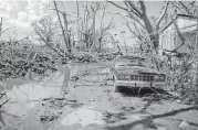  ??  ?? Mud, puddles of water and a washed-out car clutter the front of Hernan Cabrera’s house in the Media Luna neighborho­od of Toa Baja, Puerto Rico.