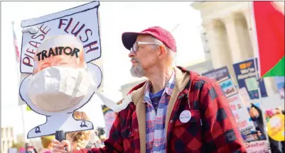  ?? PHOTO: AP ?? A protester holds a sign against former US president Donald Trump outside the US Supreme Court in Washington on Tuesday.