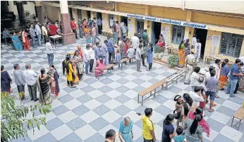  ??  ?? ON THE LINE: Voters wait in queues to cast their ballot outside a polling station during Karnataka assembly elections in Bengaluru. Intense campaignin­g has been taking place on WhatsApp.