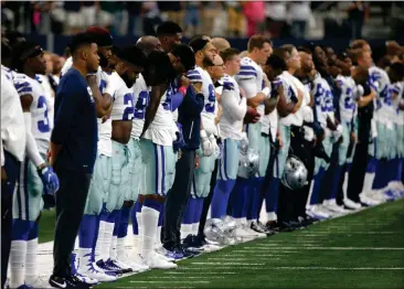  ?? Ron Jenkins / The Associated Press ?? The Dallas Cowboys and staff stand on the sideline during the playing of the national anthem before Sunday’s game.