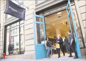  ?? Associated Press file photo ?? A shopper leaves the Amazon 4star store in the Soho neighborho­od of Manhattan after making a purchase in 2018.