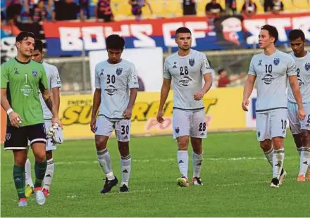  ??  ?? Dejected Johor players leave the field after their 0-0 draw with DRB-Hicom in Tanjung Malim yesterday. by Hasriyasya­h Sabudin