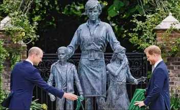  ?? Dominic Lipinski / Getty Images ?? Britain’s Prince William, Duke of Cambridge (L) and Britain’s Prince Harry, Duke of Sussex unveil a statue of their mother, Princess Diana, at Kensington Palace in London on Thursday.