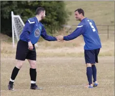  ??  ?? Colm Nolan shares a handshake with Gary Messett, wearing his dad’s number 5 jersey, before the whistle.