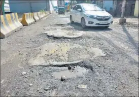  ??  ?? (From Left) Potholes on Meerut road and a road in Pandav Nagar. Commuters say potholes have taken on rainwater, posing a serious risk to motorists.