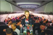  ?? Gregor Fischer / Getty Images ?? An Air Berlin flight attendant serves drinks on a flight to Berlin, Germany.