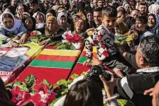  ?? Baderkhan Ahmad/Associated Press ?? Syrian Kurds attend a funeral of people killed in Turkish air strikes in the village of Al Malikiyah in northern Syria.