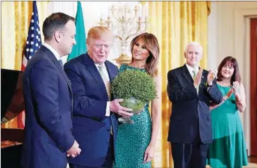  ?? MANDEL NGAN/AFP ?? US President Donald Trump holds a bowl of Shamrock presented to him by Ireland’s Prime Minister Leo Varadkar in the East Room of the White House on March 15.