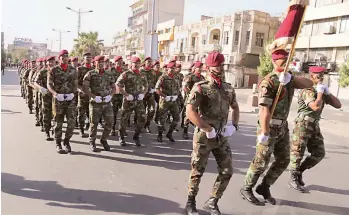  ?? — AP ?? Iraqi security force members parade in Baghdad on Thursday. Iraq marked the anniversar­y of the 1958 overthrowi­ng of the monarchy and recent victories over the extremist ISIS group with a military parade staged in central Baghdad.