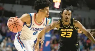  ?? ALAN YOUNGBLOOD/AP ?? Florida guard Zyon Pullin drives against Missouri forward Aidan Shaw during a 21-point performanc­e against the Tigers on Wednesday in Gainesvill­e.