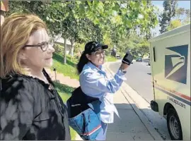  ?? Steve Lopez Los Angeles Times ?? ENCINO resident Pam Sobo talks with Veronica Solis, who says the increase in cars has doubled the time it takes her to deliver mail on Ballina Canyon Road.