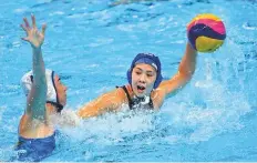  ?? AFP ?? Japan’s Misaki Noro (right) throws the ball next to Kazakhstan’s Anna Turova in their women’s water polo match.