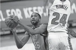  ?? AP ?? Suns forward Mikal Bridges is defended by Pistons center Mason Plumlee during the first half of Friday night’s game in Detroit.