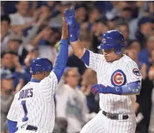  ?? DENNIS WIERZBICKI, USA TODAY SPORTS ?? Willson Contreras celebrates with Gary Jones after homering to give the Cubs a lead Wednesday.