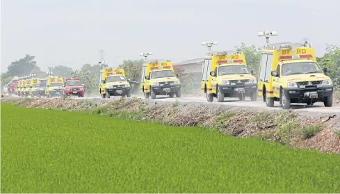  ?? Some of the 176 fire trucks being transporte­d from a warehouse in Nonthaburi to four fire stations in Bangkok for repair after being left unused for a decade, following City Hall’s controvers­ial purchase of the vehicles. CHANAT KATANYU ??