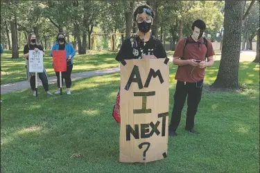  ?? (AP/David Kolpack) ?? Protesters assemble at a Fargo, N.D. park before a planned march to City Hall to mark the Juneteenth celebratio­ns and press city leaders to make changes to police policy and open communicat­ion in the wake of the deaths of George Floyd and others.