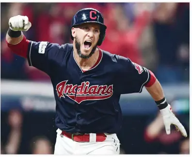  ??  ?? Cleveland Indians’ Yan Gomes celebrates after hitting a game-winning single off New York Yankees relief pitcher Dellin Betances in the 13th inning of Game 2 of a baseball American League Division Series Friday in Cleveland. Austin Jackson scored on the play. The Indians won 9-8. (AP)