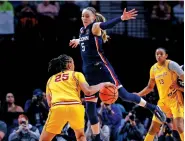  ?? HOWARD LAO/THE ASSOCIATED PRESS ?? UConn guard Paige Bueckers, No. 5, tries to block Southern California guard McKenzie Forbes during an Elite Eight game in the NCAA Tournament in Portland, Ore.