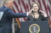  ?? ALEX BRANDON — THE ASSOCIATED PRESS ?? President Donald Trump adjusts the microphone after he announced Judge Amy Coney Barrett as his nominee to the Supreme Court, in the Rose Garden at the White House, Saturday, Sept. 26.