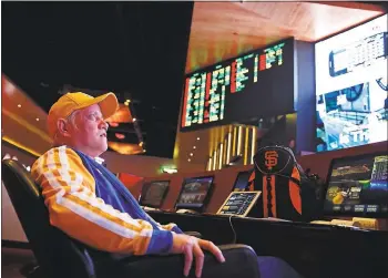  ?? PHOTOS BY JOHN LOCHER — THE ASSOCIATED PRESS FILE ?? Amado Nanalang watches basketball games at a sports book owned by CG Technology in Las Vegas. The Supreme Court is set to hear arguments challengin­g a law that forbids state-authorized sports gambling in all but four states.