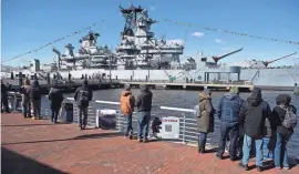  ?? LACHALL/USA TODAY NETWORK – ATLANTIC GROUP CHRIS ?? A crowd views the Battleship New Jersey on Thursday on the Camden Waterfront prior to the ship's departure for a dry dock maintenanc­e project.