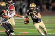  ?? GENE WALSH — DIGITAL FIRST MEDIA ?? La Salle quarterbac­k Danny Solecki finds running room against Archbishop Carroll.